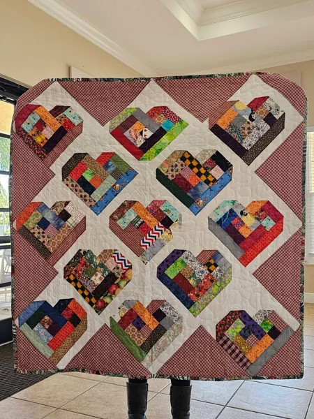 Handmade quilt with colorful blocks on a light background