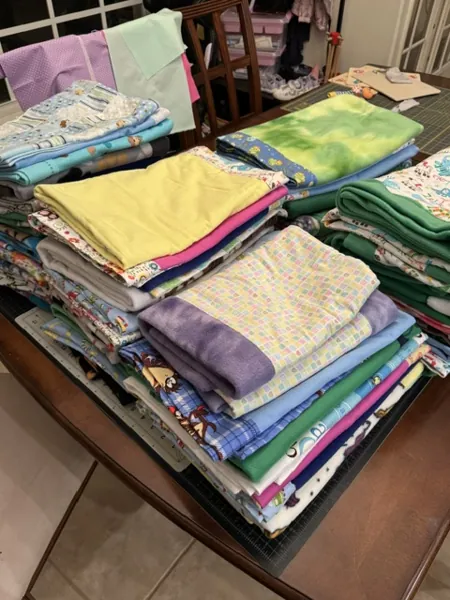 Stacks of handmade blankets on a table